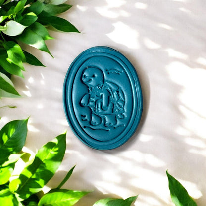 Finished clay oval with school turtle and subtle waves