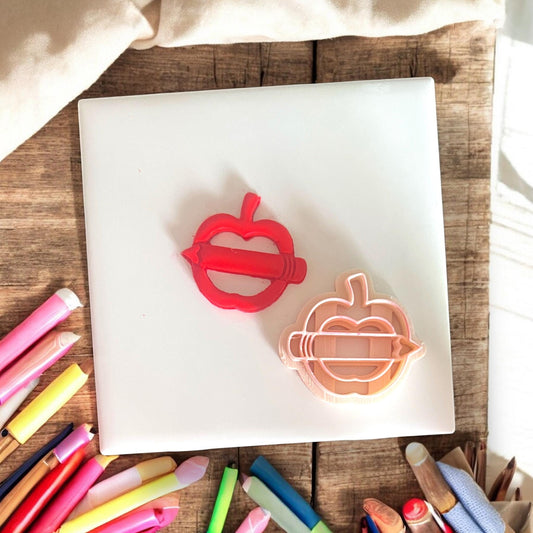 Polymer clay cutter next to matching red clay piece