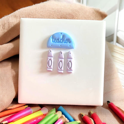 Finished earring components with blue “teacher” top and three crayons