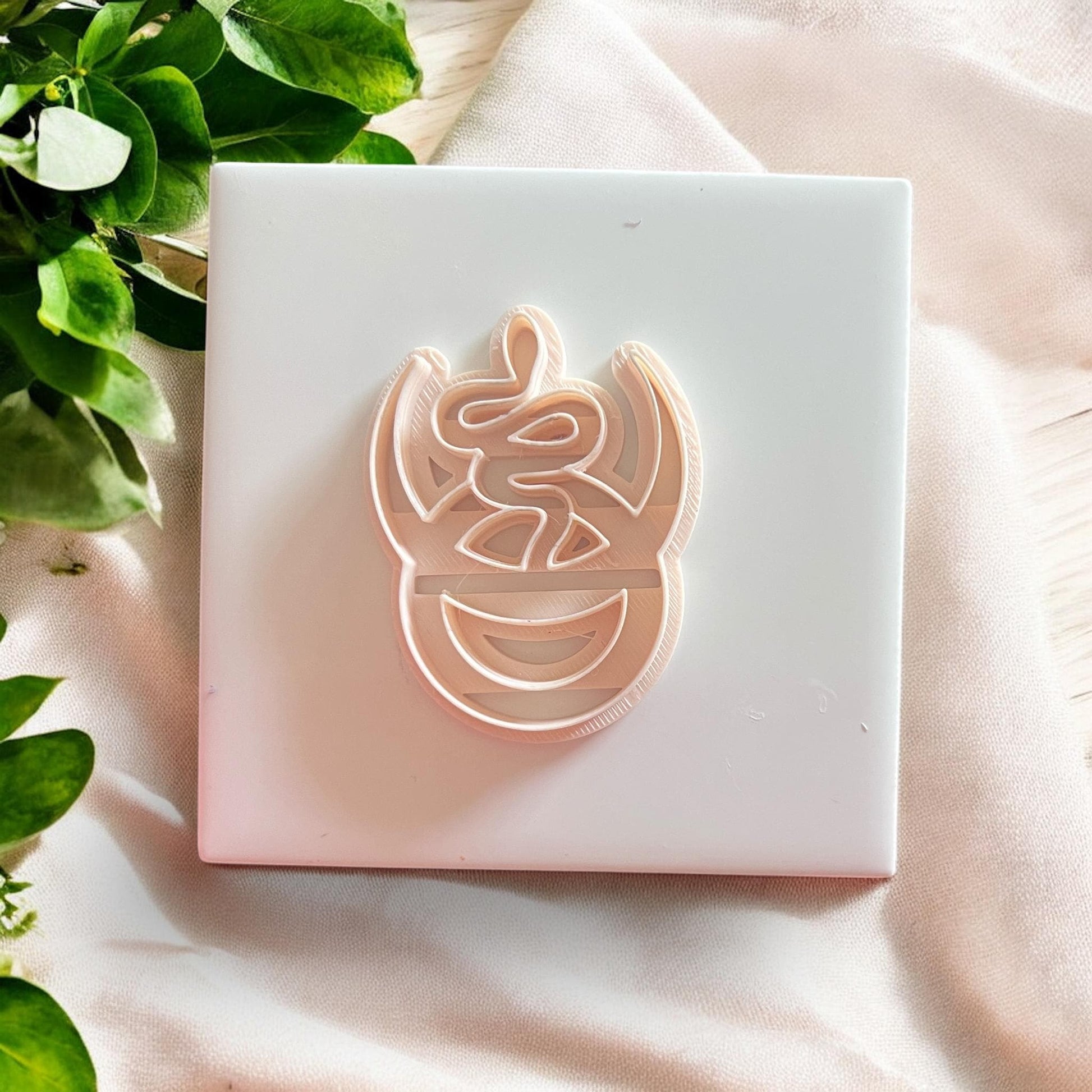 Top-down view of full snake cutter on tile with soft shadows