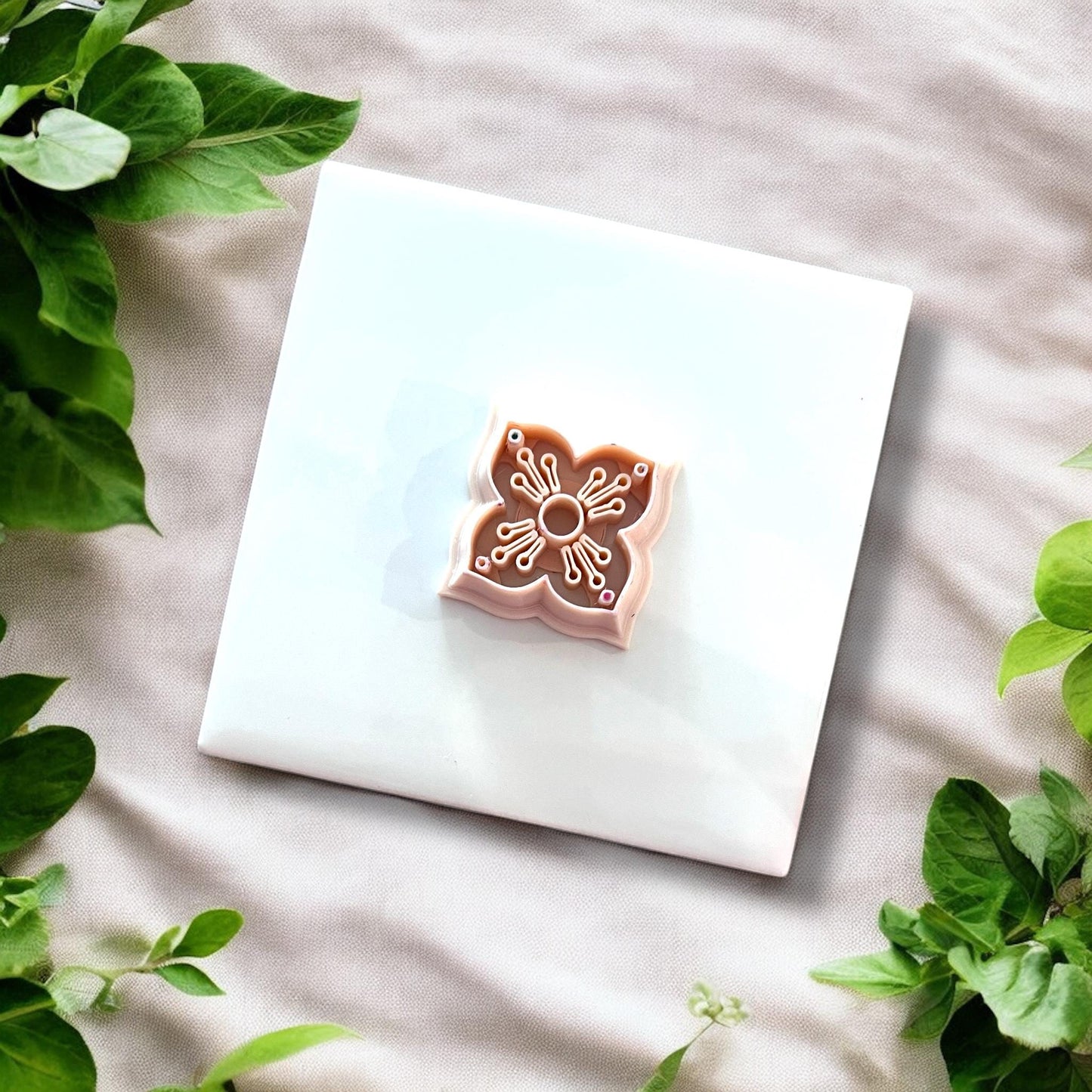 Top view of the floral cutter with etched details visible