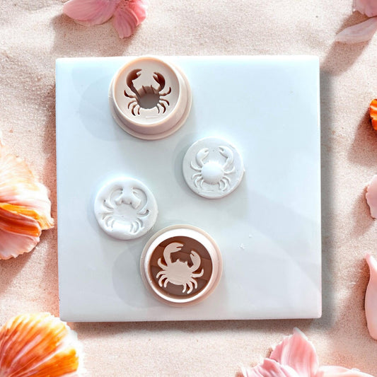Clay crab studs with matching cutters beside them