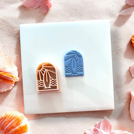 Surfboard arch clay cutter next to blue clay result