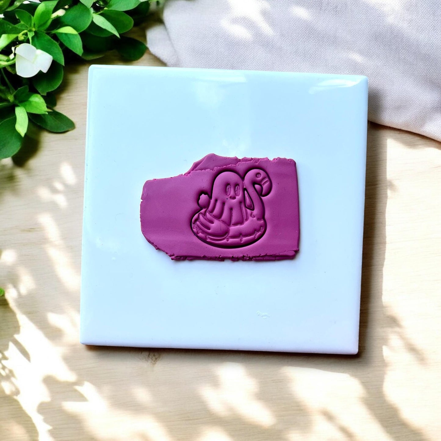 Clay slab impression of ghost riding flamingo floatie