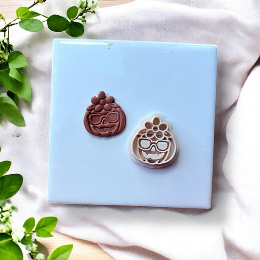 clay pumpkin next to polymer clay cutter