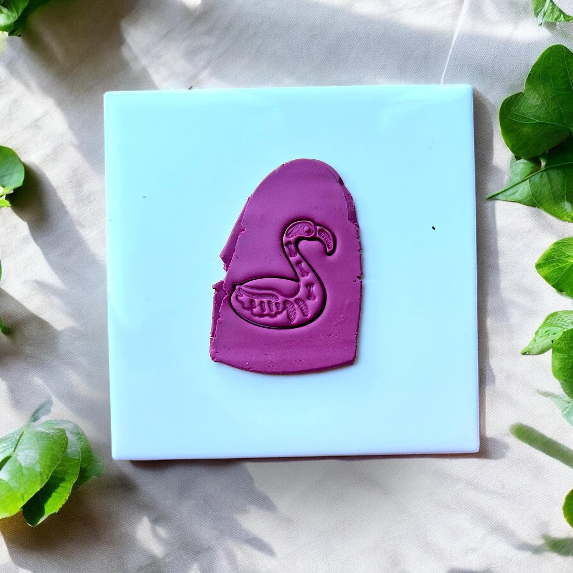 spooky flamingo clay impression on tile