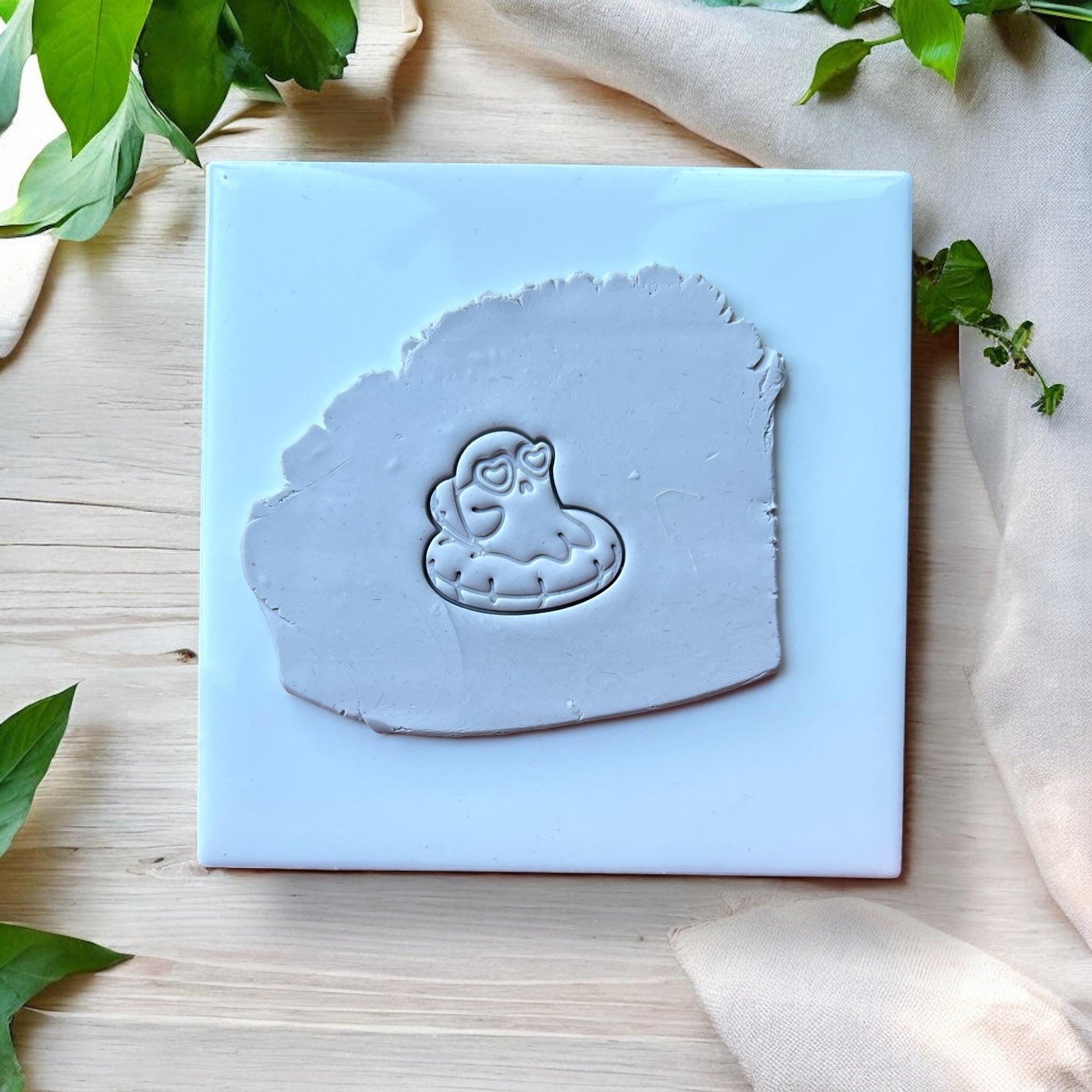Ghost pool float impression in grey clay