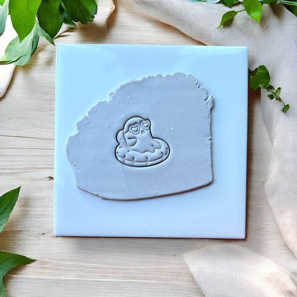 Ghost pool float impression in grey clay