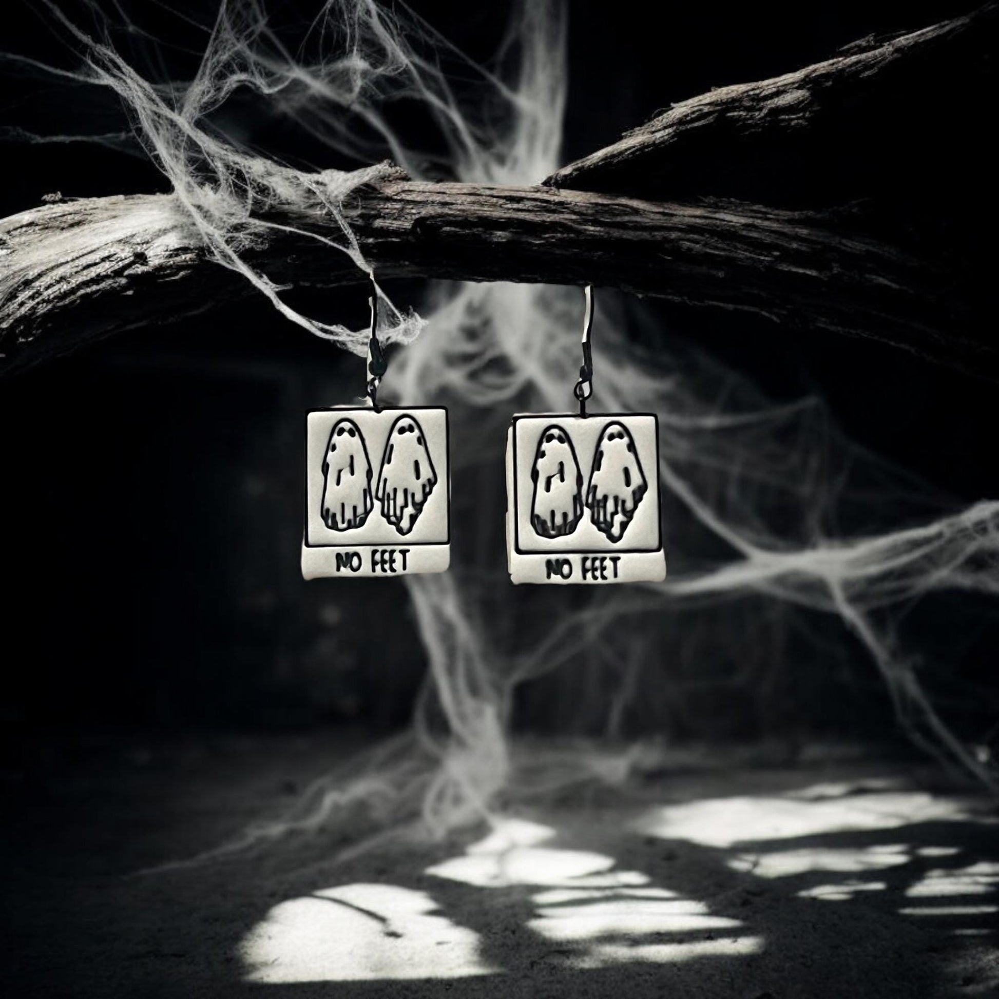 Finished No Feet ghost earrings hanging from spooky branch
