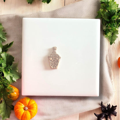 Lantern polymer clay shape on white tile