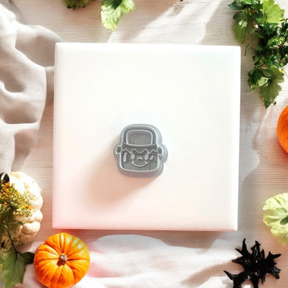 Gray Frankenstein bucket cutter on white tile