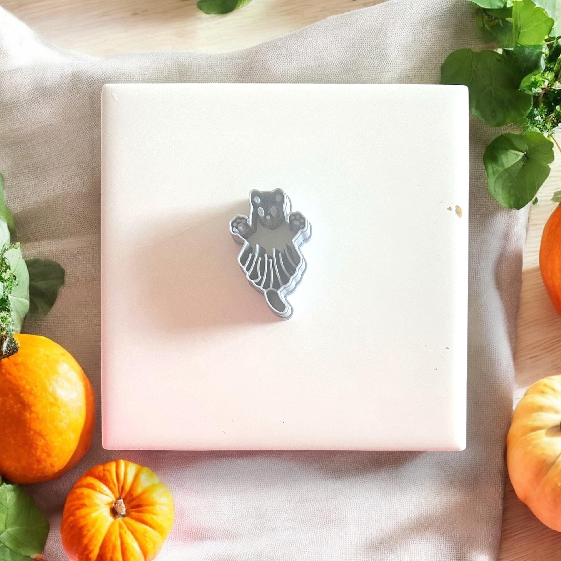 Gray sugar glider ghost cutter on white tile