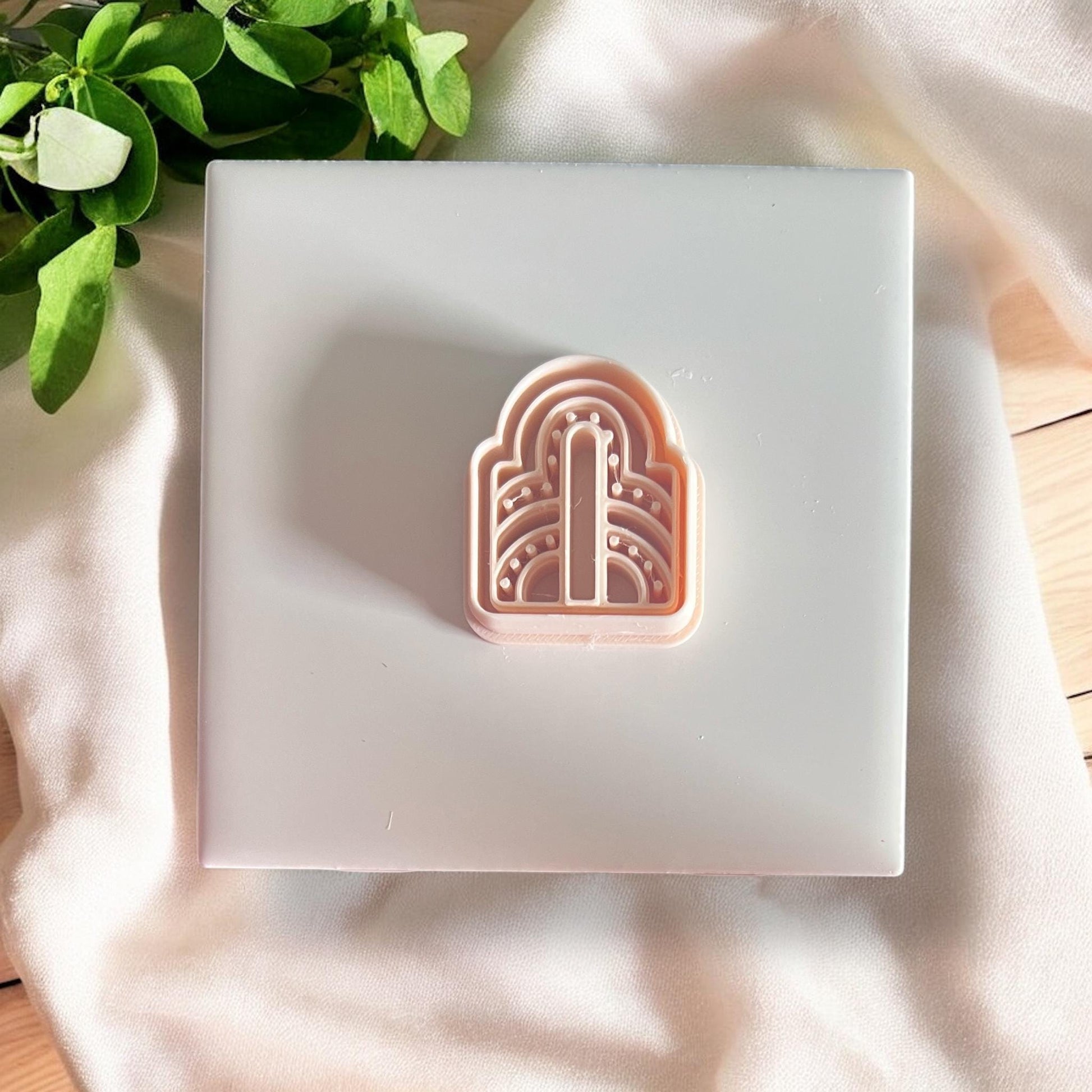 Art deco clay cutter on white tile
