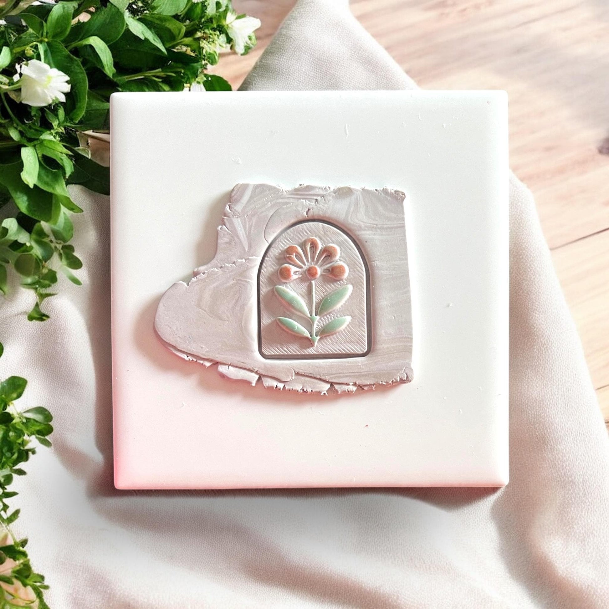 Arched floral cutter impression pressed into slab