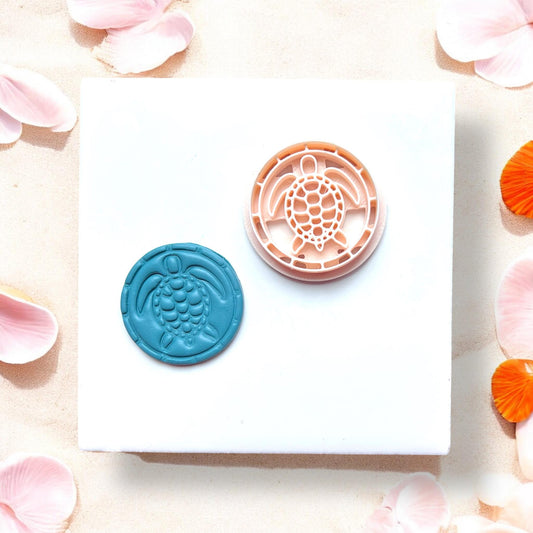 Clay cutter and finished sea turtle piece side by side on white background