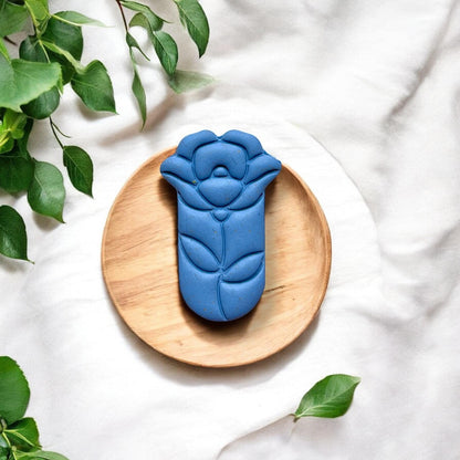 Finished blue teardrop flower clay piece on wood plate