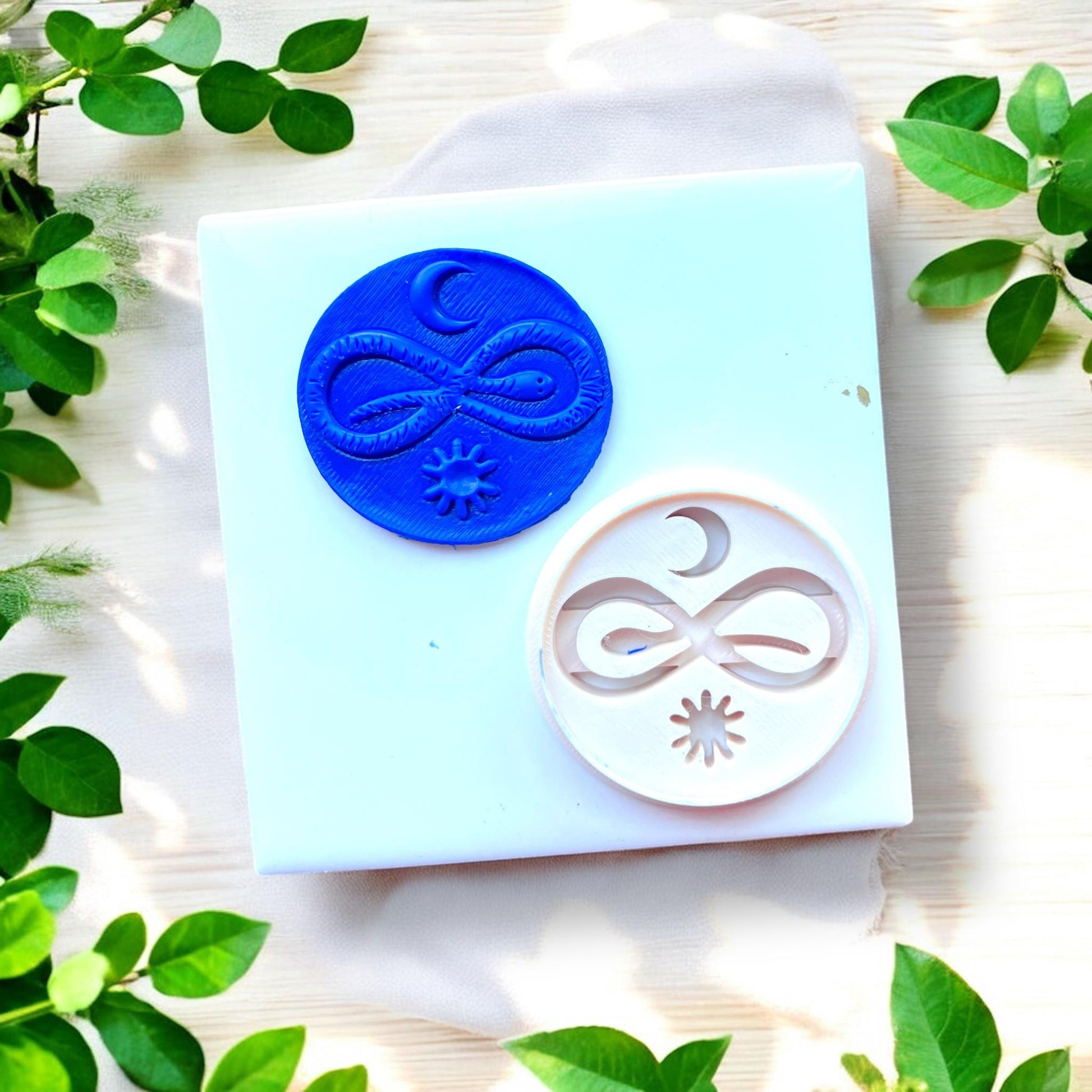 blue clay charm next to matching cutter