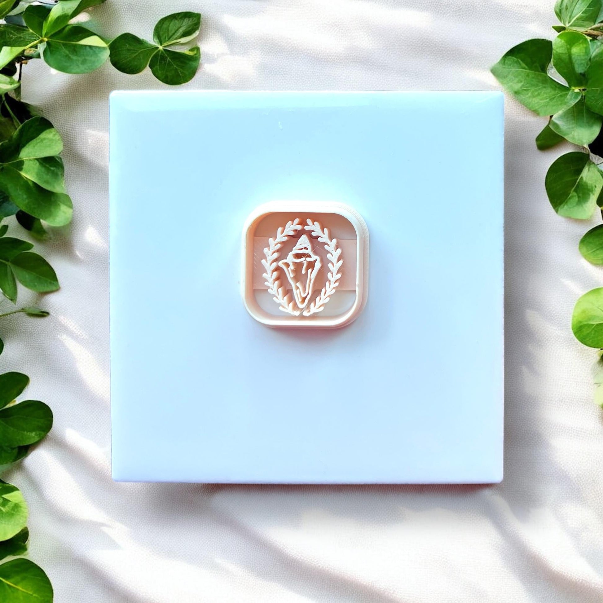 white rounded square cutter with shell and leaf