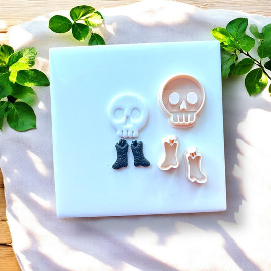skull and boot charms next to matching clay cutters