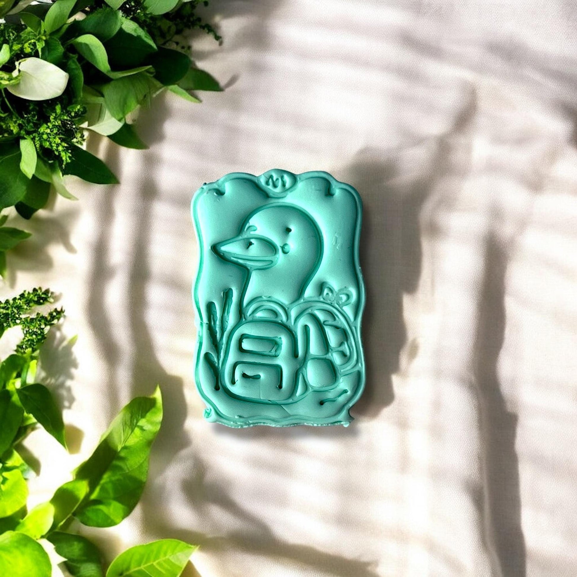 Finished duck clay piece with wavy border and leaf accents