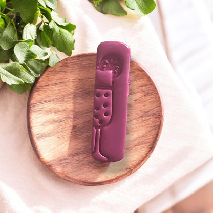 Close-up of mimosa glass clay cutout on wooden round base