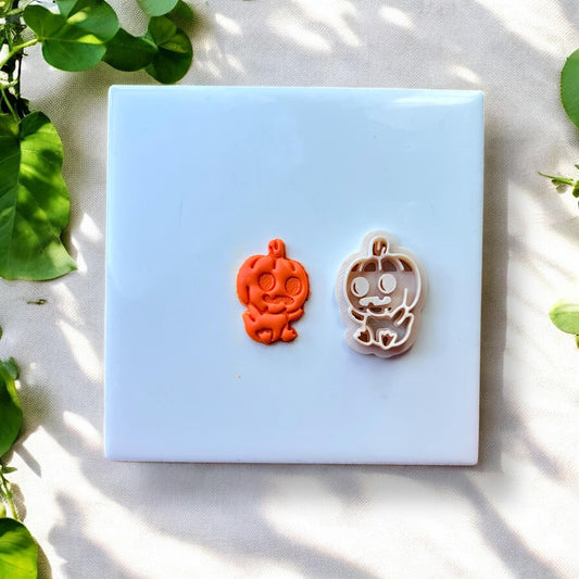 Finished orange and white pumpkin baby earrings