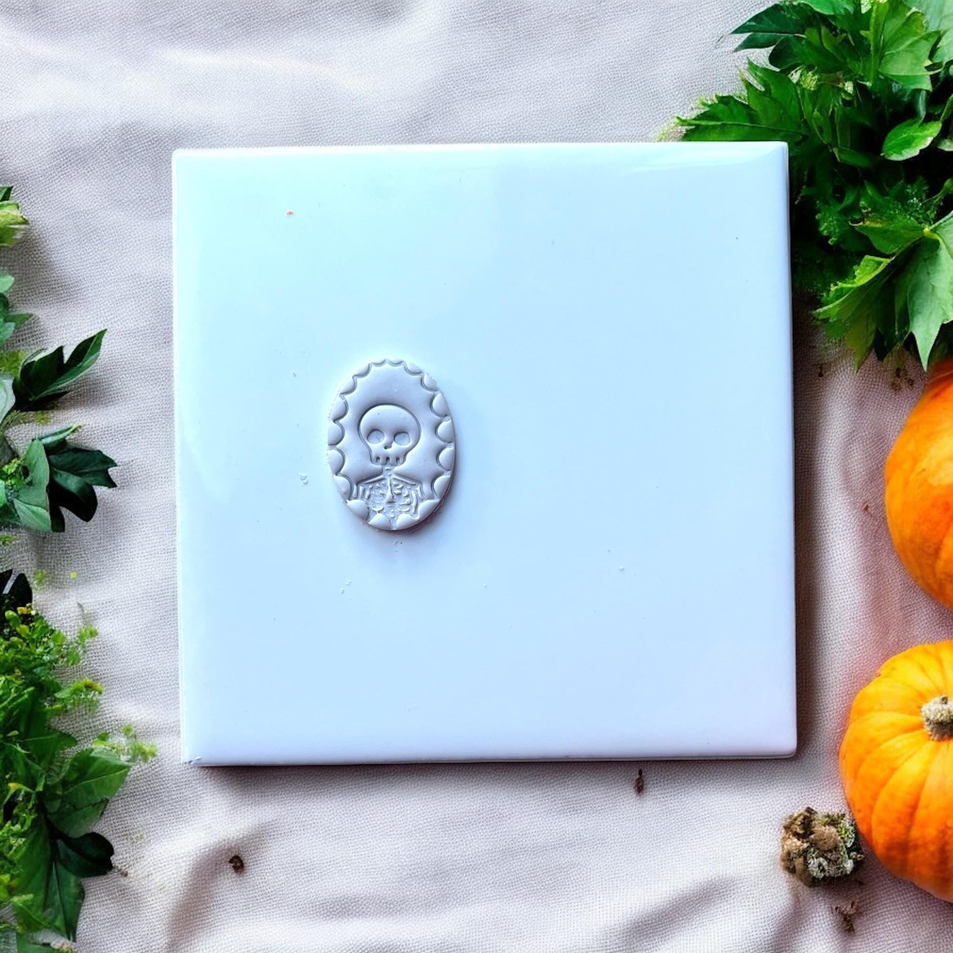 skeleton cameo clay shape on white tile