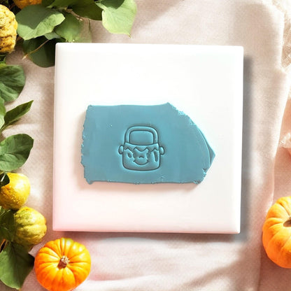 Frankenstein candy bucket cutter pressed into blue clay