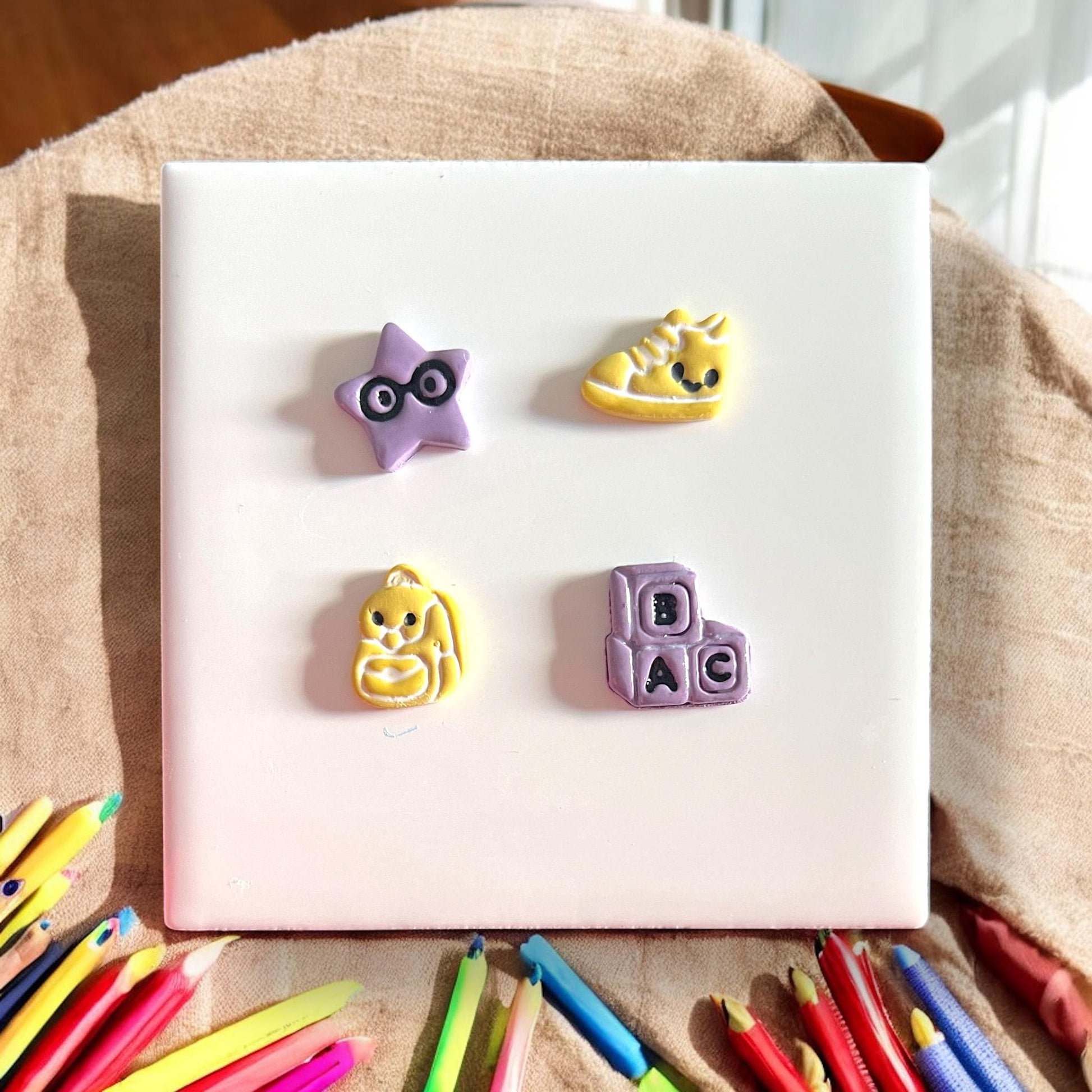 finished purple yellow school studs