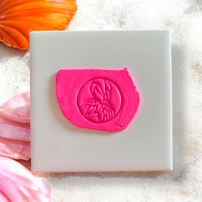 Flamingo silhouette clay impression in bright pink polymer clay