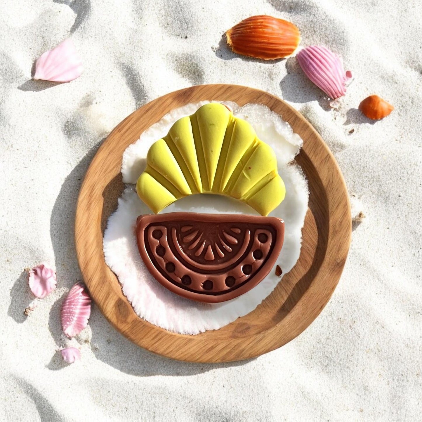 Clay earring styled on sand with seashells