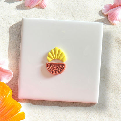 Completed clay earring with shell and semi-circle cutout