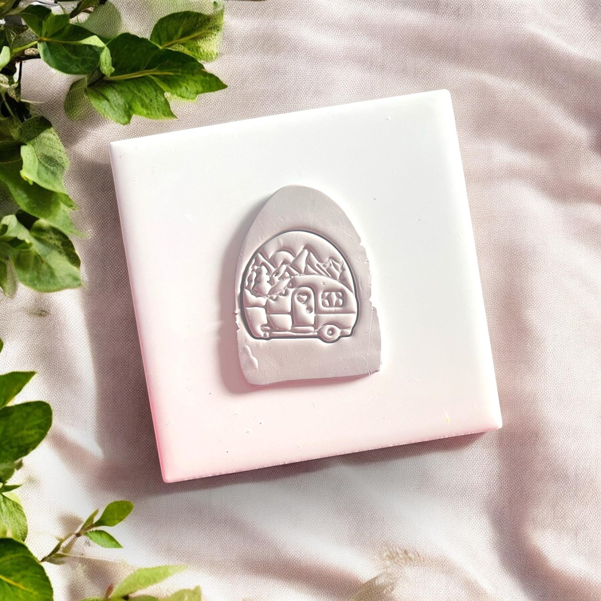 closeup of clay cut with camper design