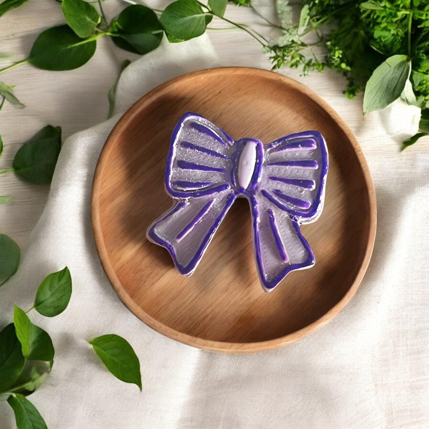 finished clay earring shaped like a girly ribbon bow