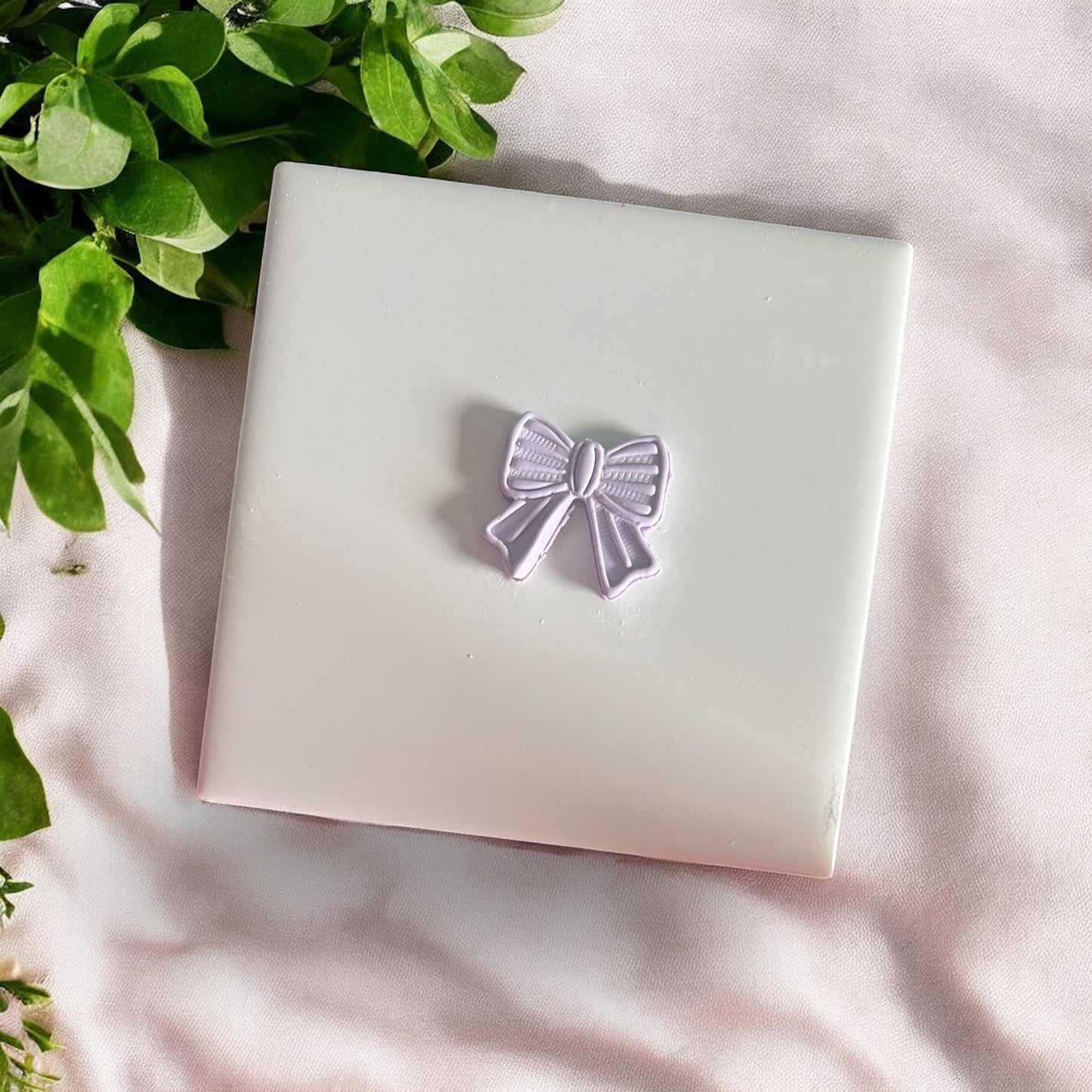 polymer clay bow dangle with ridged detail