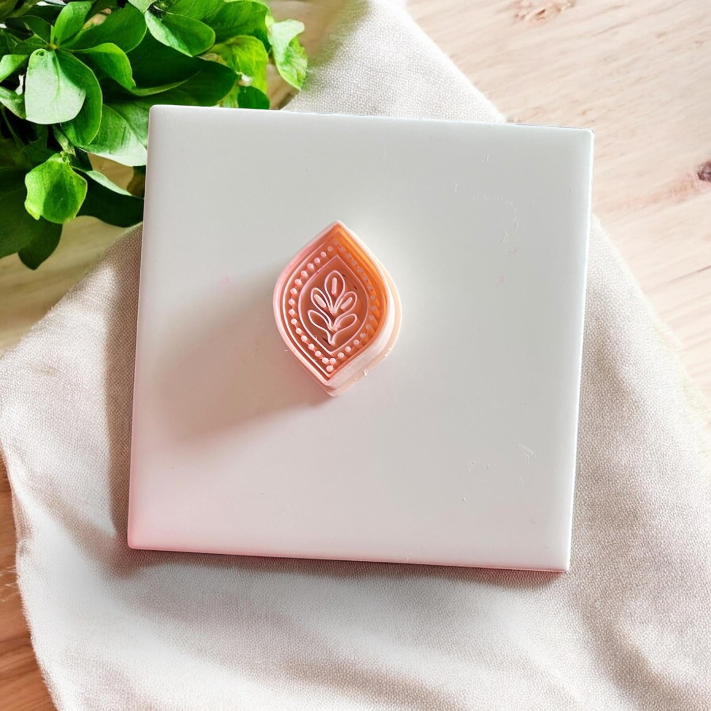 Folk-inspired leaf petal polymer clay cutter on white tile