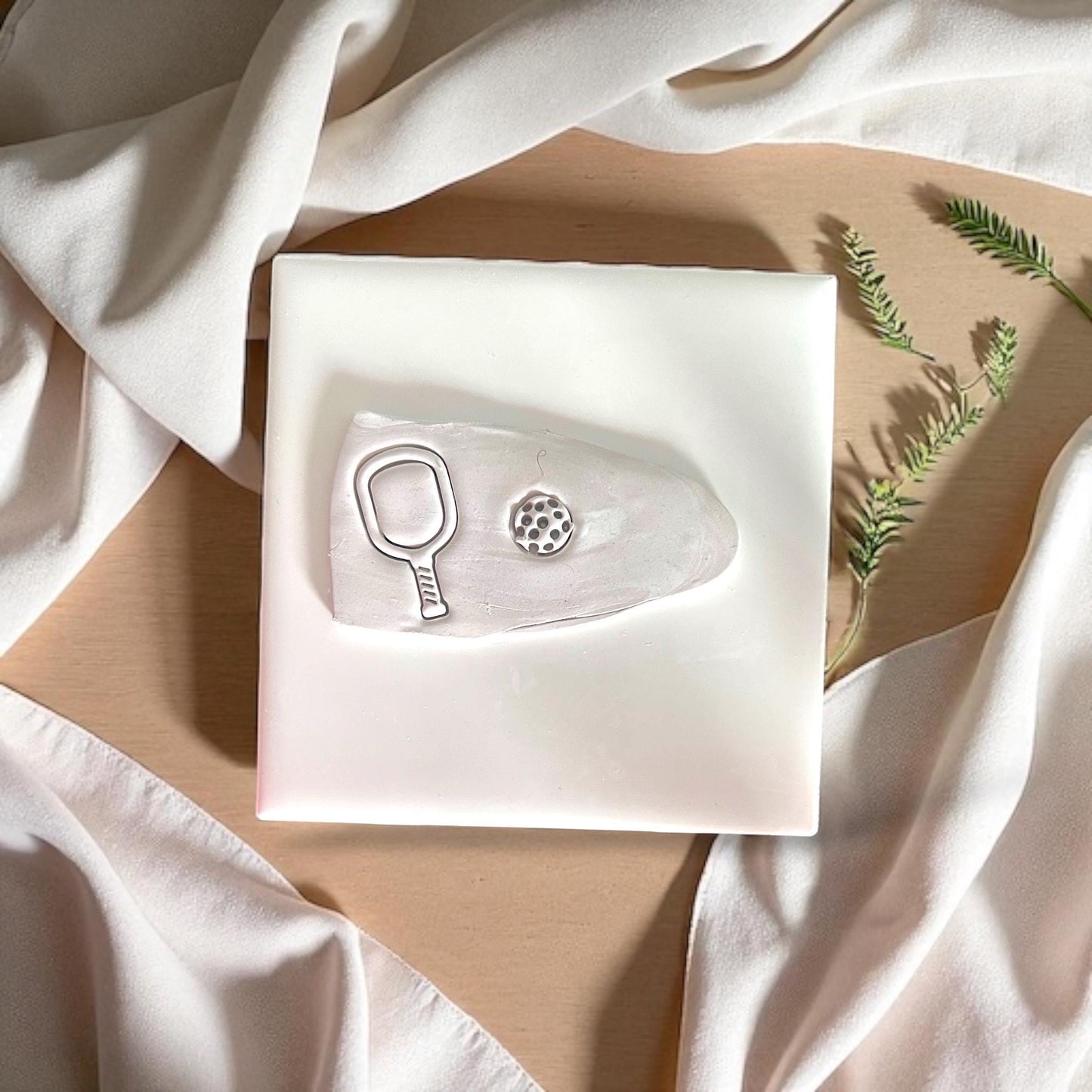 pickleball racket and ball clay cut