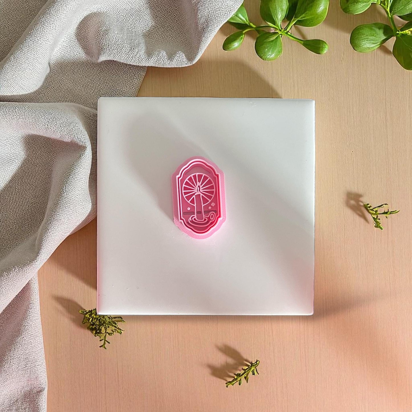 candle in window polymer clay cutter on white tile with pink rim