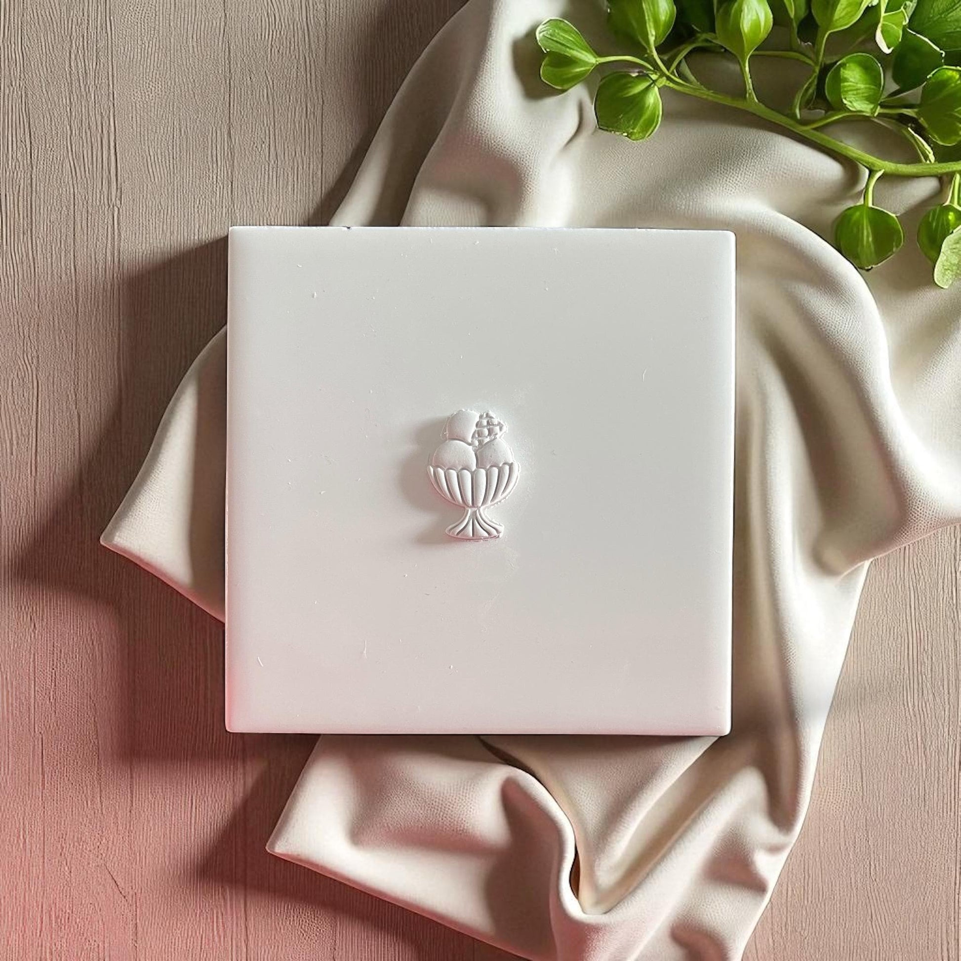 Clay sundae mold on white base with soft fabric