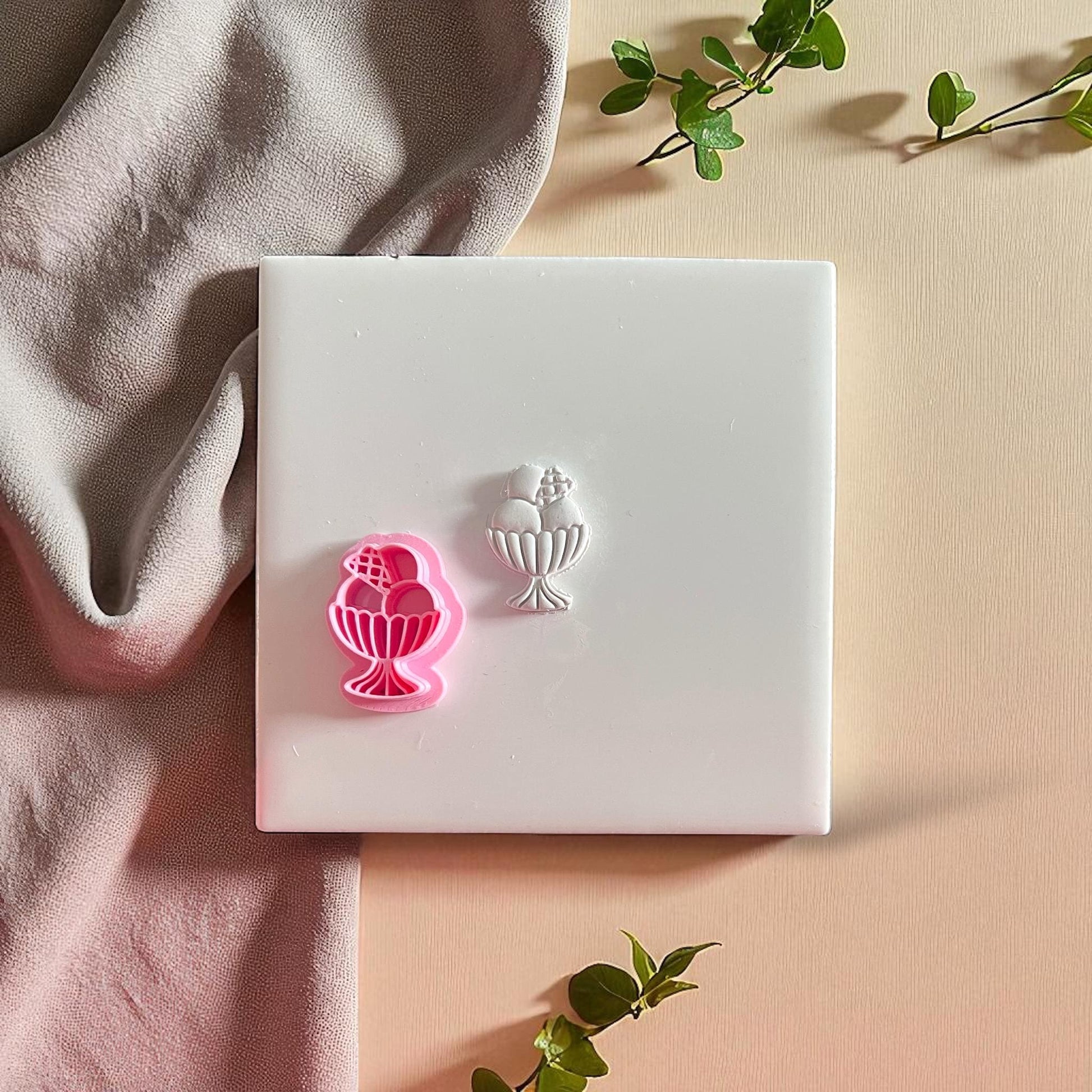 Pink clay cutter and sundae clay impression on display