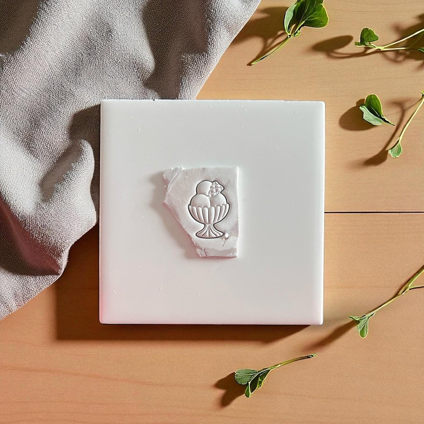 Ice cream sundae clay impression on white tile