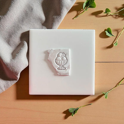 Ice cream sundae clay impression on white tile