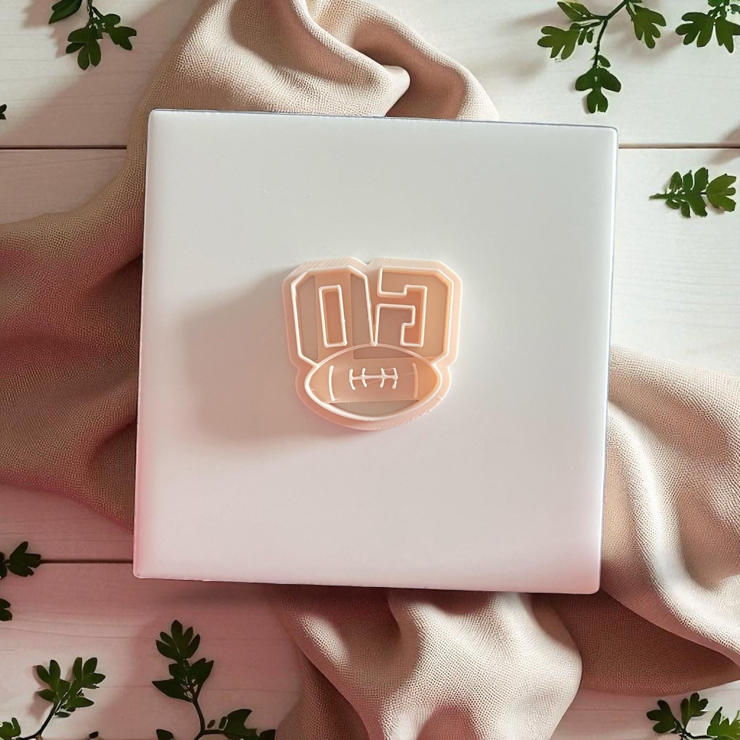 Football-themed GO polymer clay cutter shown on white display tile