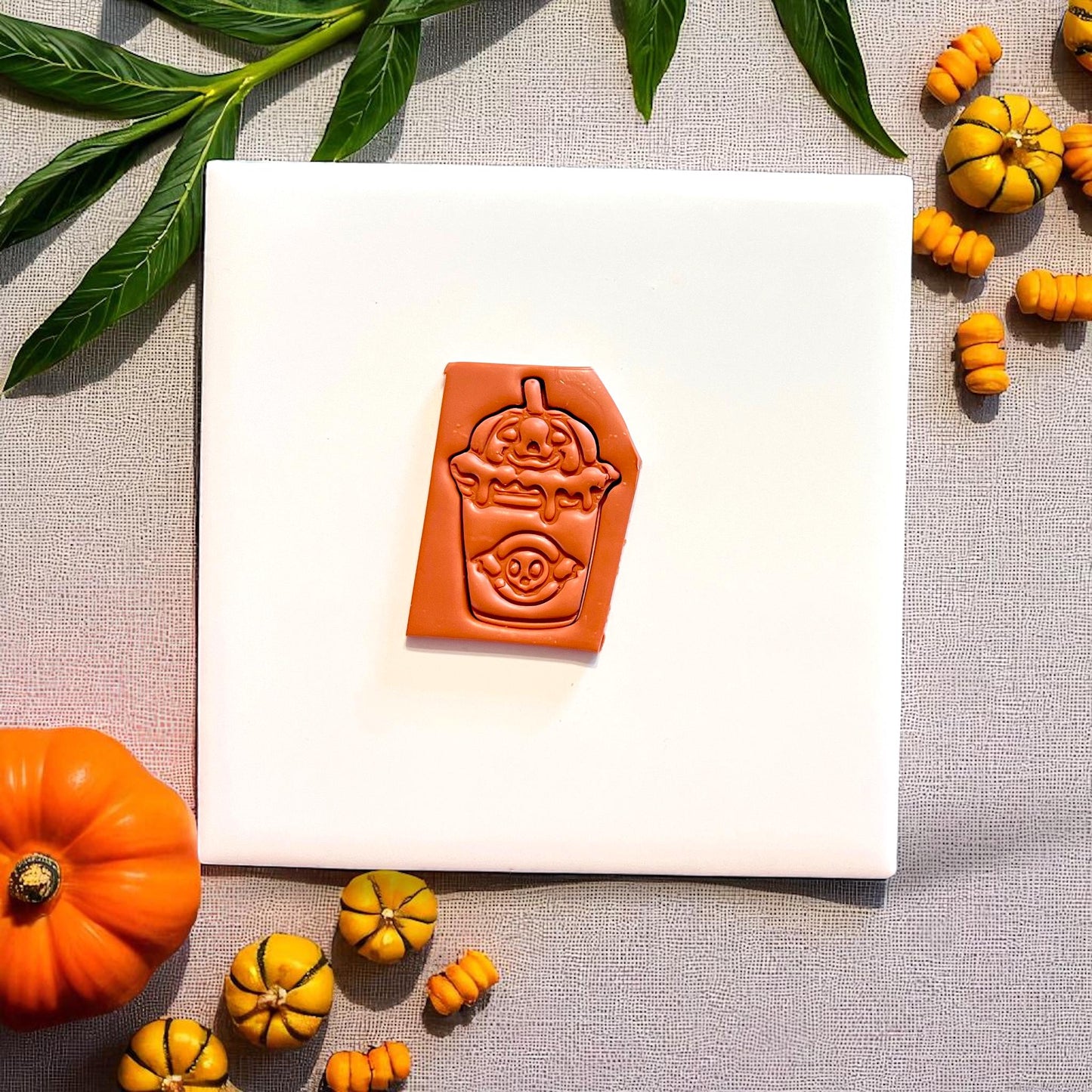 Close-up of spooky boba clay imprint showing ghost and pumpkin drink details