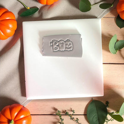 BOO word impression in clay with pumpkin and ghost design