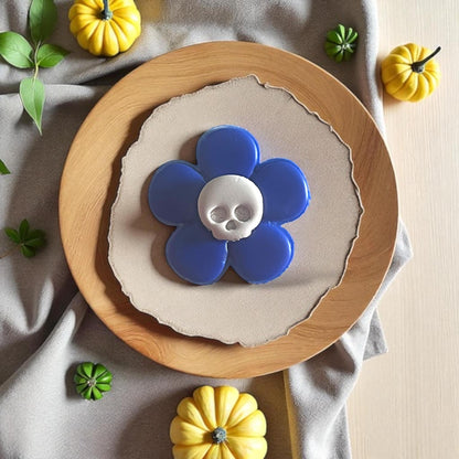 Blue flower with white skull center displayed on wood plate