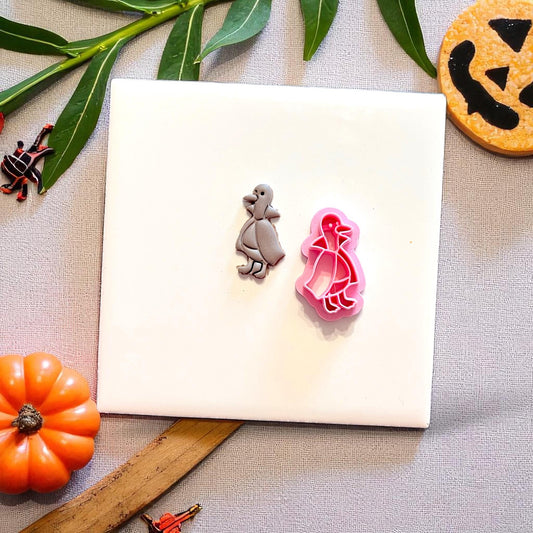 Duckula polymer clay earring next to the pink cutter