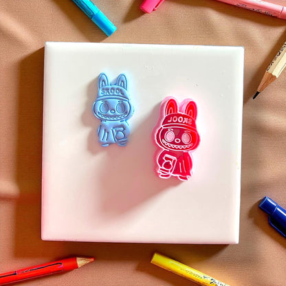 Monster clay cutter and blue clay imprint featuring a book design