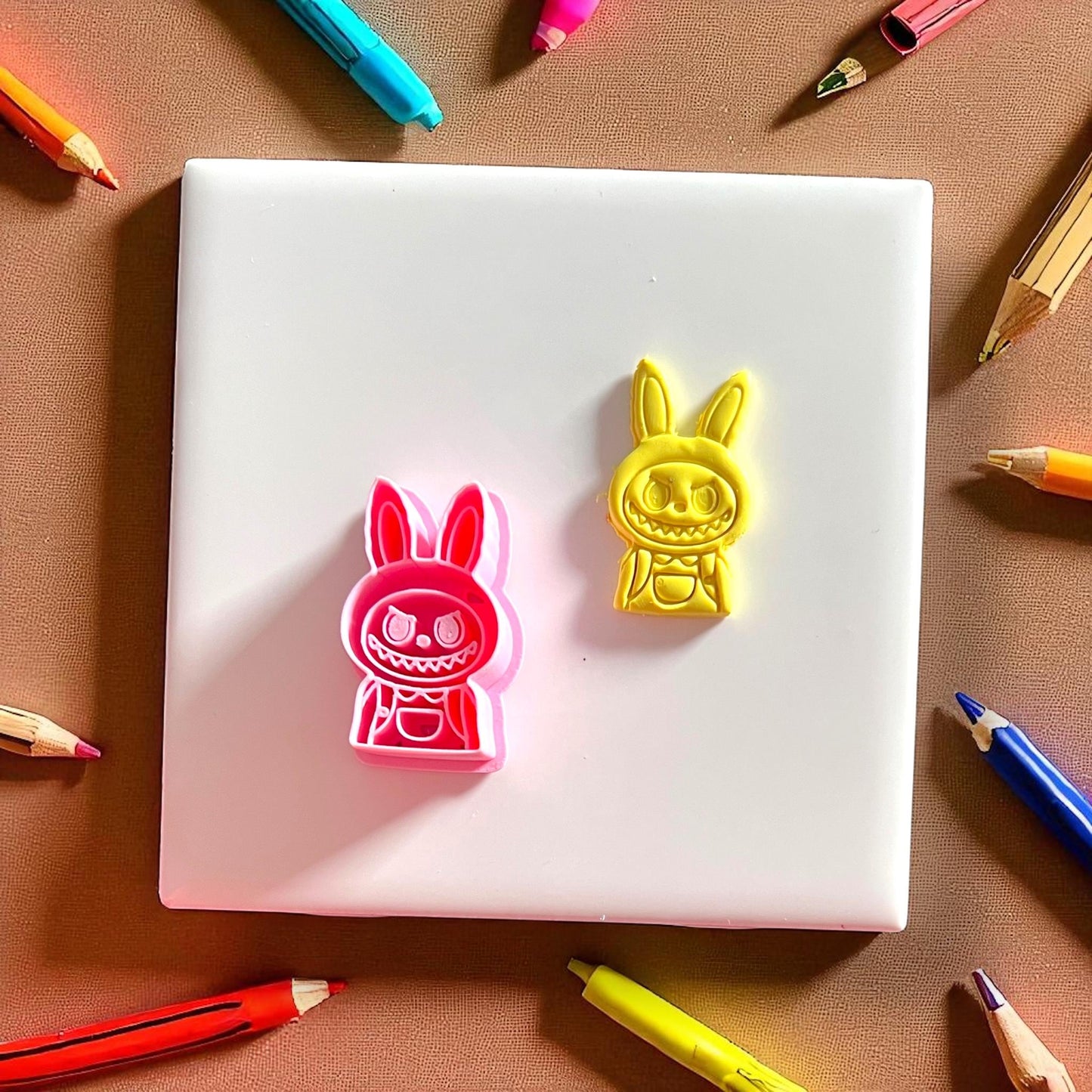 Monster boy polymer clay cutter and finished yellow clay design side by side