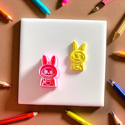 Monster boy polymer clay cutter and finished yellow clay design side by side